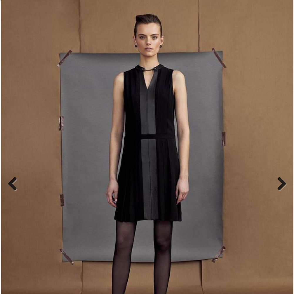 Etcetera black dress with leather trim and delicate chain at neckline.